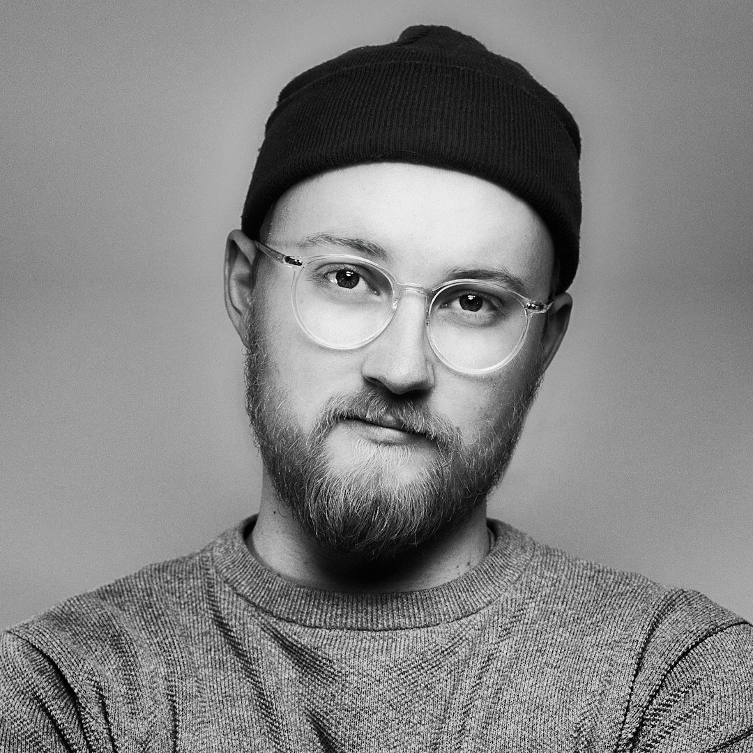Studio portrait of a young Portuguese man developer with glasses