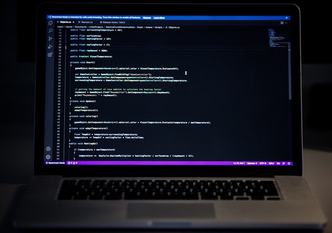 programmer writing code on laptop