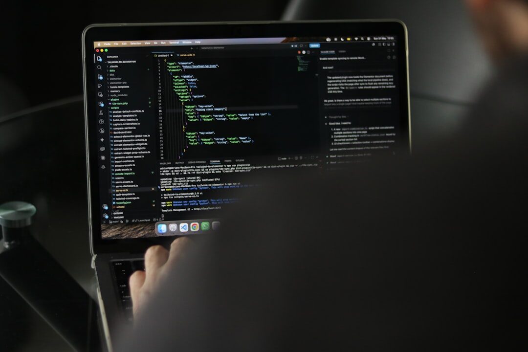 person coding on laptop